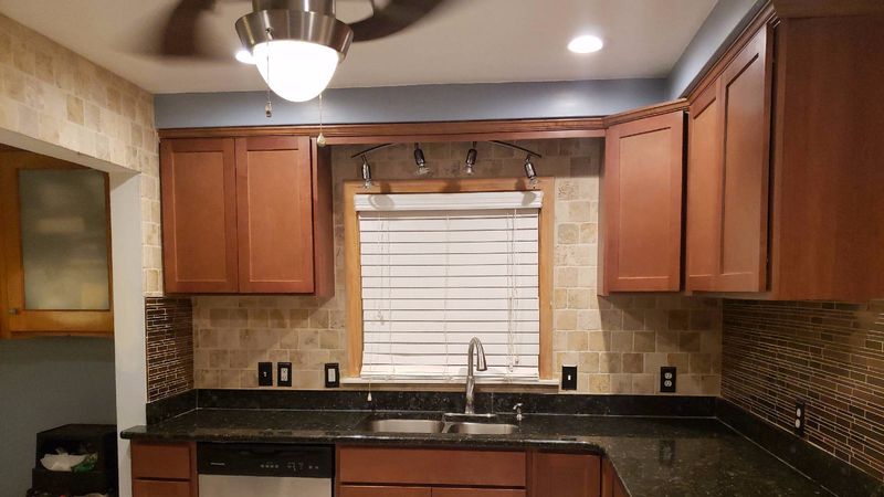 New kitchen cabinets above a granite counter and undermount sink